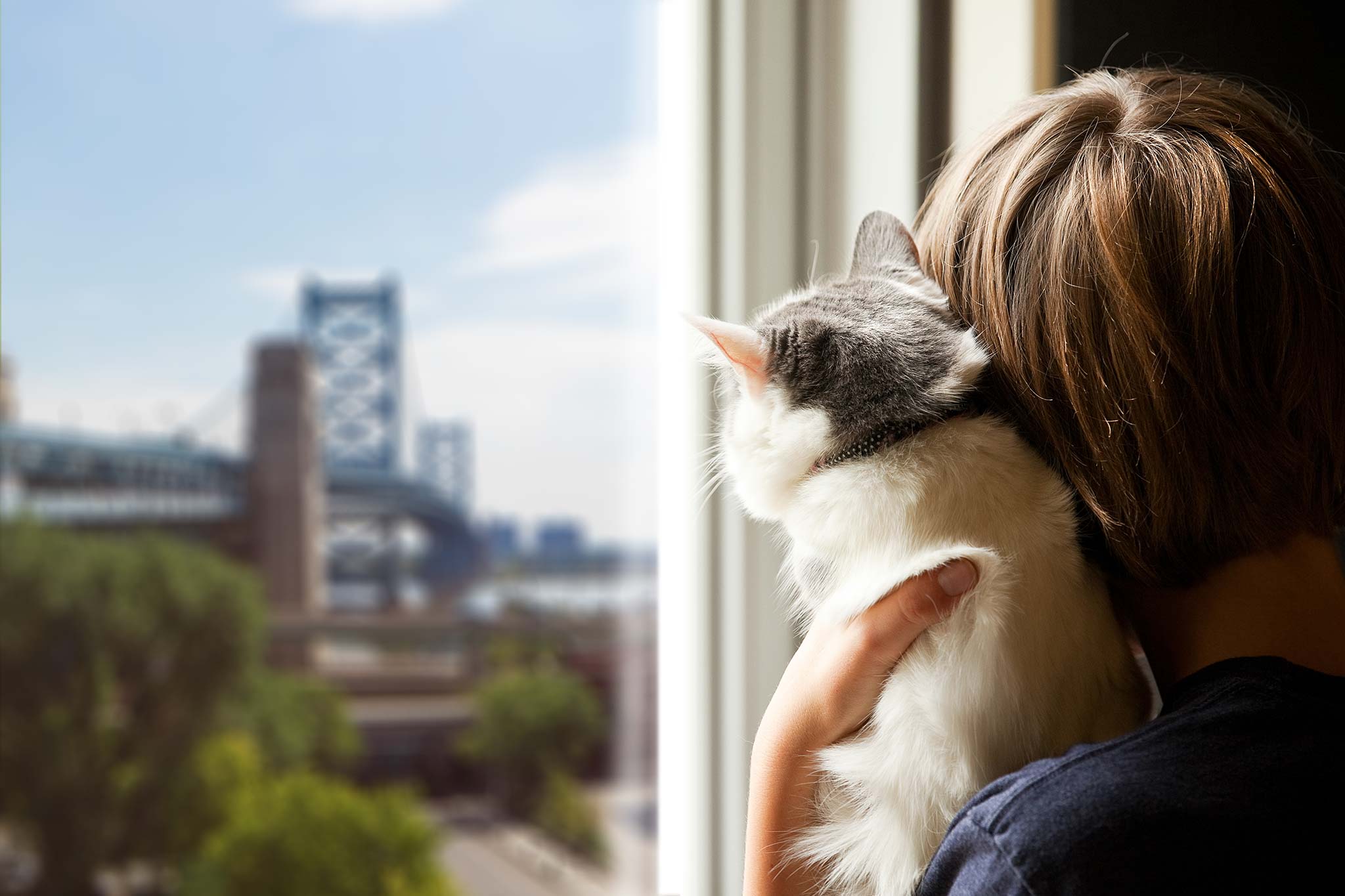 Woman With Cat Looking at Bridge